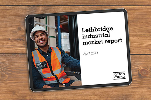 photo of a tablet on a table displaying Avison Young's Lethbridge industrial market report April 2023
