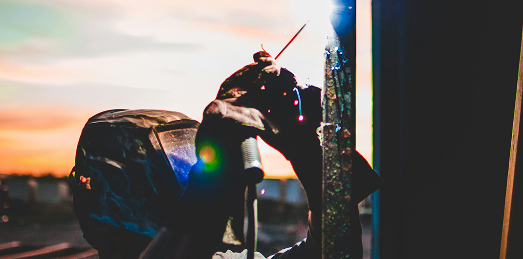 a welder working on a high rise