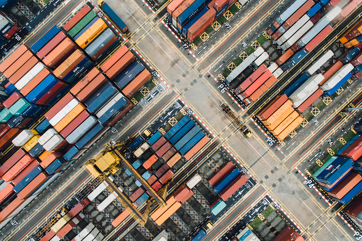 aerial view of frieght containers stacked in an industrial port