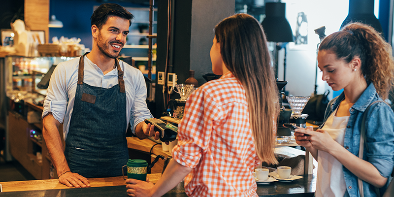 photo of customers making a purchase at a retail counter