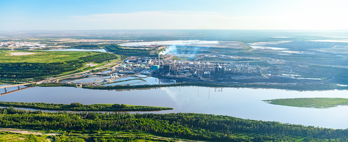 aerial view of an industrial facility near on the banks fo a river